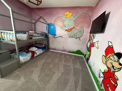 a bedroom with a mickey mouse mural on the wall at ☀️12BR Disney Villa Paradise w/ Game Room & Pool/Spa☀️ in Kissimmee