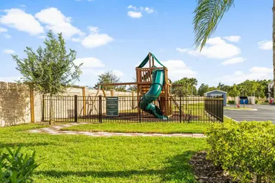 a playground with a slide in a park at Modern Family-Friendly Townhome – 10 Min Parks in Kissimmee