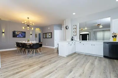 a kitchen and dining room with a table in it at Windsor Oasis 6BR Pool Game Room 9 min Disney in Orlando