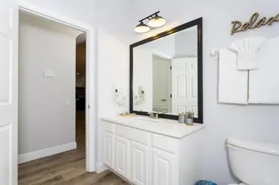 a bathroom with a sink and a mirror at Windsor Oasis 6BR Pool Game Room 9 min Disney in Orlando