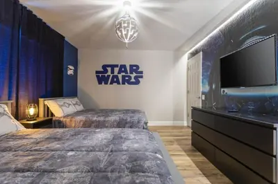 a star wars bedroom with two beds and a tv at Windsor Oasis 6BR Pool Game Room 9 min Disney in Orlando