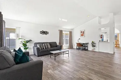 a living room with a couch and a table at Amazing Pool Spacious 3BR House near Disney in Kissimmee