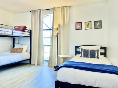 a bedroom with two bunk beds and a window at Beautiful 3BR House with Private Pool near Disney in Kissimmee