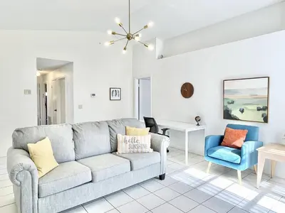 a living room with a couch and a chair at Beautiful 3BR House with Private Pool near Disney in Kissimmee