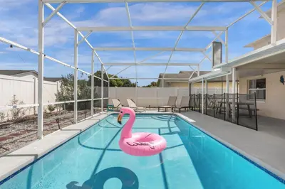 a swimming pool with a pink swan in the middle at Amazing Blue Private Pool 4BR House Near Disney in Kissimmee