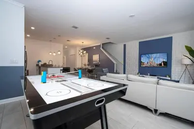a kitchen and living room with a couch and a table at Gorgeous 4 Bd w Pool at Storey Lake Resort 4277 in Kissimmee
