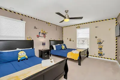a bedroom with two beds and a ceiling fan at Near Disney - 5BR Home- Games Pool Hot Tub & BBQ in Kissimmee