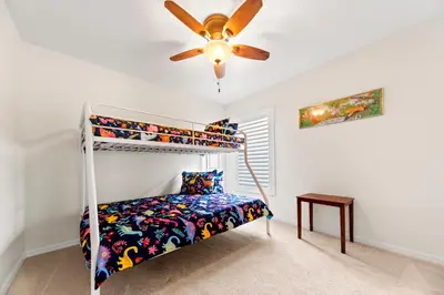 a bedroom with a bunk bed and a ceiling fan at Private Oasis in Kissimmee - Pool, BBQ, Free Parking in Orlando