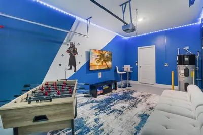 a room with blue walls and a table with guns at Storey Lake Resort, Private Pool, And Much More!! in Kissimmee