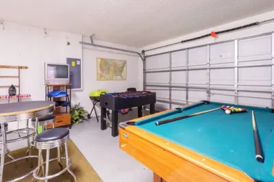 a room with a pool table and a bar at Restful 4BR 3BA with BBQ, Heated Pool & SPA in Kissimmee
