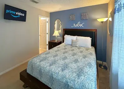 a bedroom with a bed and a sign on the wall at Comfort Home with BBQ, Private Pool & Hot tub in Kissimmee