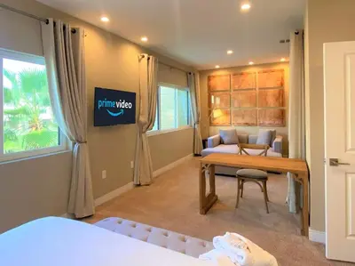 a room with a bed and a desk and a couch at Family Home w BBQ, 7 Min from Disney, Accessible in Orlando