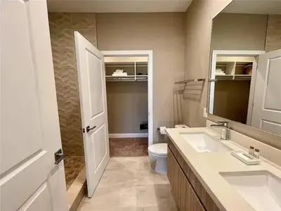 a bathroom with a sink and a toilet and a mirror at Family Home w BBQ, 7 Min from Disney, Accessible in Orlando
