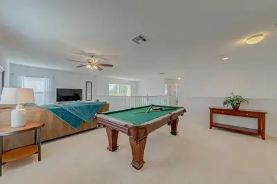 a living room with a pool table in it at 558 - Veranda Palms House in Kissimmee