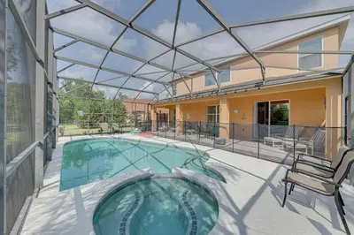 a swimming pool with a glass roof on a house at 558 - Veranda Palms House in Kissimmee