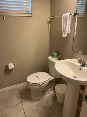 a bathroom with a toilet and a sink at Vacation Home for 8, near Disney and Universal in Kissimmee