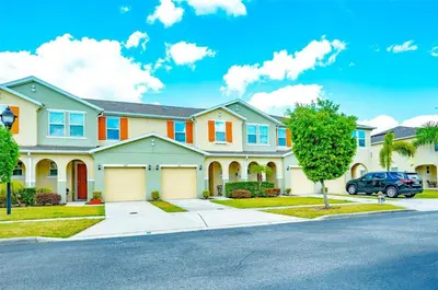 a house with a car parked in a driveway at Vacation Home for 8, near Disney and Universal in Kissimmee