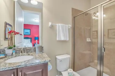 a bathroom with a toilet and a sink and a shower at 450 Paradise 8BD Villa- Game Room PoolSpa in Orlando