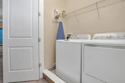 a laundry room with a washing machine and a door at 450 Paradise 8BD Villa- Game Room PoolSpa in Orlando