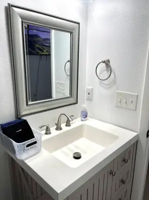 a bathroom with a white sink and a mirror at Peaceful Home in Central Florida Near Universal in Orlando