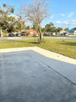 a concrete parking lot with a tree in a park at Peaceful Home in Central Florida Near Universal in Orlando
