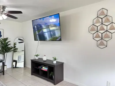 a living room with a tv on a wall at Peaceful Home in Central Florida Near Universal in Orlando
