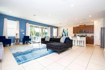 a living room with a couch and a table at Unforgettable Experience Luxury Vacation Home 7479 in Orlando