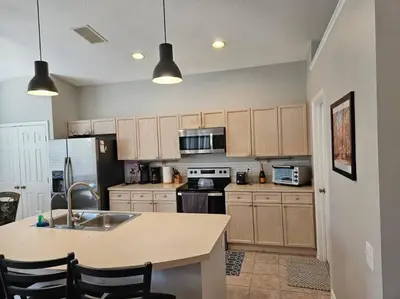 a kitchen with a sink and a counter top at Family Friendly Disney Villa (4 Miles from Disney) in Kissimmee