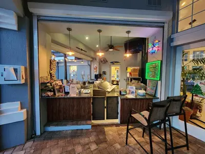 a restaurant with two chairs in front of a counter at Family Friendly Disney Villa (4 Miles from Disney) in Kissimmee