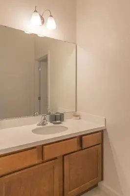 a bathroom with a sink and a large mirror at Summer Fun - Waterfront 8BR Home with Private Pool! in Kissimmee