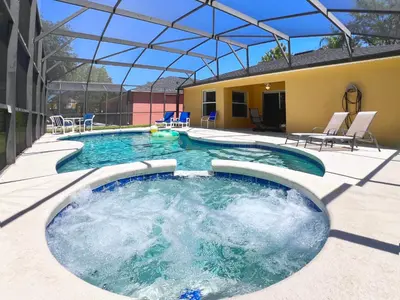 a swimming pool with chairs and a building at Lovely 3-Bedroom Pool Villa-1445SCD in Orlando