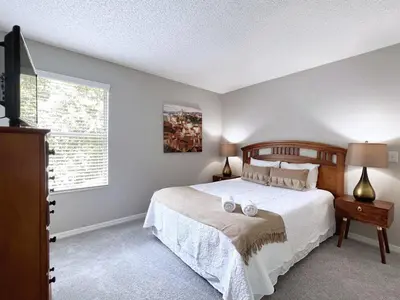 a bedroom with a large bed and a window at Spacious 7Bd Pool Gm Hm Terra Verde Resort-211HBL in Kissimmee