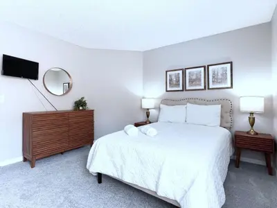 a bedroom with a white bed with two white pillows at Spacious 7Bd Pool Gm Hm Terra Verde Resort-211HBL in Kissimmee