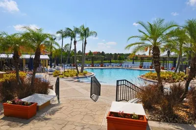 a pool at a resort with palm trees at Spacious 7Bd Pool Gm Hm Terra Verde Resort-211HBL in Kissimmee