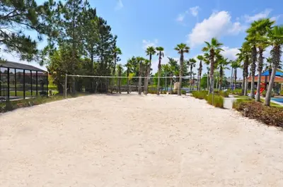 an empty volleyball court at a resort with palm trees at Spacious 7Bd Pool Gm Hm Terra Verde Resort-211HBL in Kissimmee