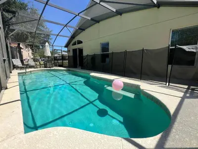 a swimming pool with a pink ball in the water at Cozy 4 Bed 3 Bath Pool Hm with Game Room-4450NP in Kissimmee
