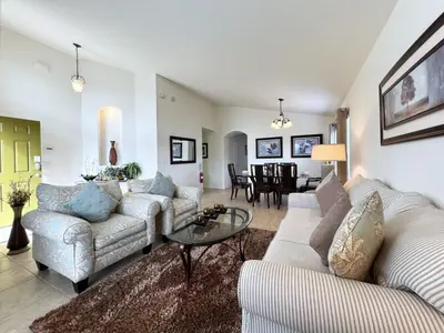 a living room with two couches and a table at Cozy 4 Bed 3 Bath Pool Hm with Game Room-4450NP in Kissimmee