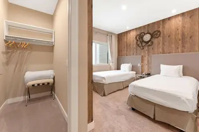 a hotel room with two beds and a window at 7594 Magic Village 3suites 6guets 8 min Disney in Orlando