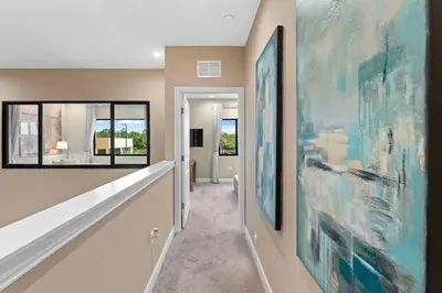 a hallway with large paintings on the walls at 7583 Magic Village jacuzzi 3 suites near 192 and Disney in Orlando