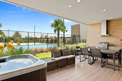 a living room with a hot tub and a table and chairs at 7583 Magic Village jacuzzi 3 suites near 192 and Disney in Orlando