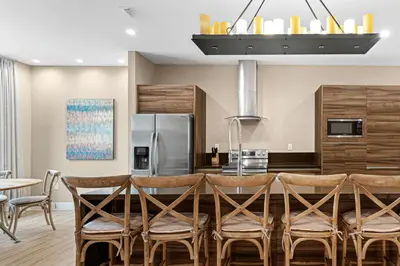 a kitchen with a table and chairs and a refrigerator at 7545 Magic Village 4 suites 8 guests 8 min Disney in Orlando