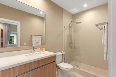 a bathroom with a sink and a toilet and a shower at 7545 Magic Village 4 suites 8 guests 8 min Disney in Orlando