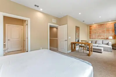 a bedroom with a bed and a couch and a table at 7545 Magic Village 4 suites 8 guests 8 min Disney in Orlando