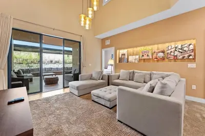a living room with couches and a couch and a table at 3081 Magic Village 4suites Jacuzzi Near 192 8 min Disney in Orlando