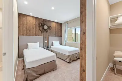 a bedroom with two beds and a window at 3081 Magic Village 4suites Jacuzzi Near 192 8 min Disney in Orlando