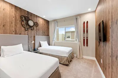 a hotel room with two beds and a window at 3081 Magic Village 4suites Jacuzzi Near 192 8 min Disney in Orlando