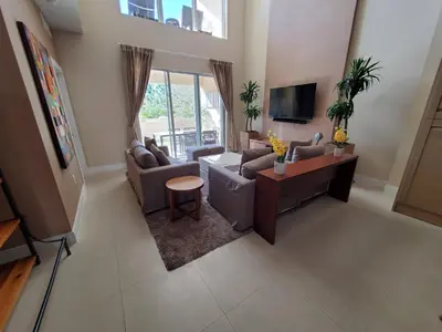 a living room with two couches and a tv at 7659 Magic Village Excellent 4 suites 6 min Disney in Orlando