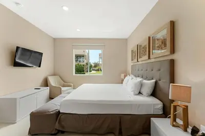 a bedroom with a large bed and a window at 7648 Magic Village lovely 4suites 8guests 8 min Disney in Orlando