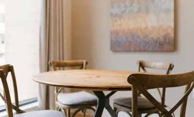 a dining room table with chairs and a painting at 7490 Magic Village 4suites 8 guests 8 min Disney in Orlando