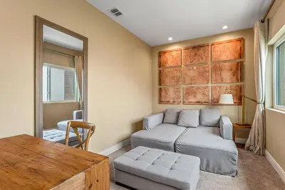 a living room with a couch and a table at 7490 Magic Village 4suites 8 guests 8 min Disney in Orlando